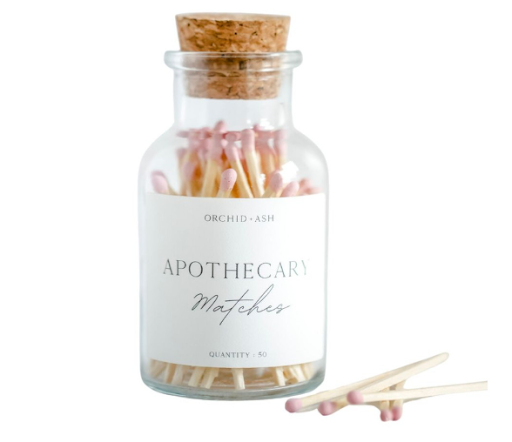 Minimalist match set in soft pink packaging displayed on a clean surface.