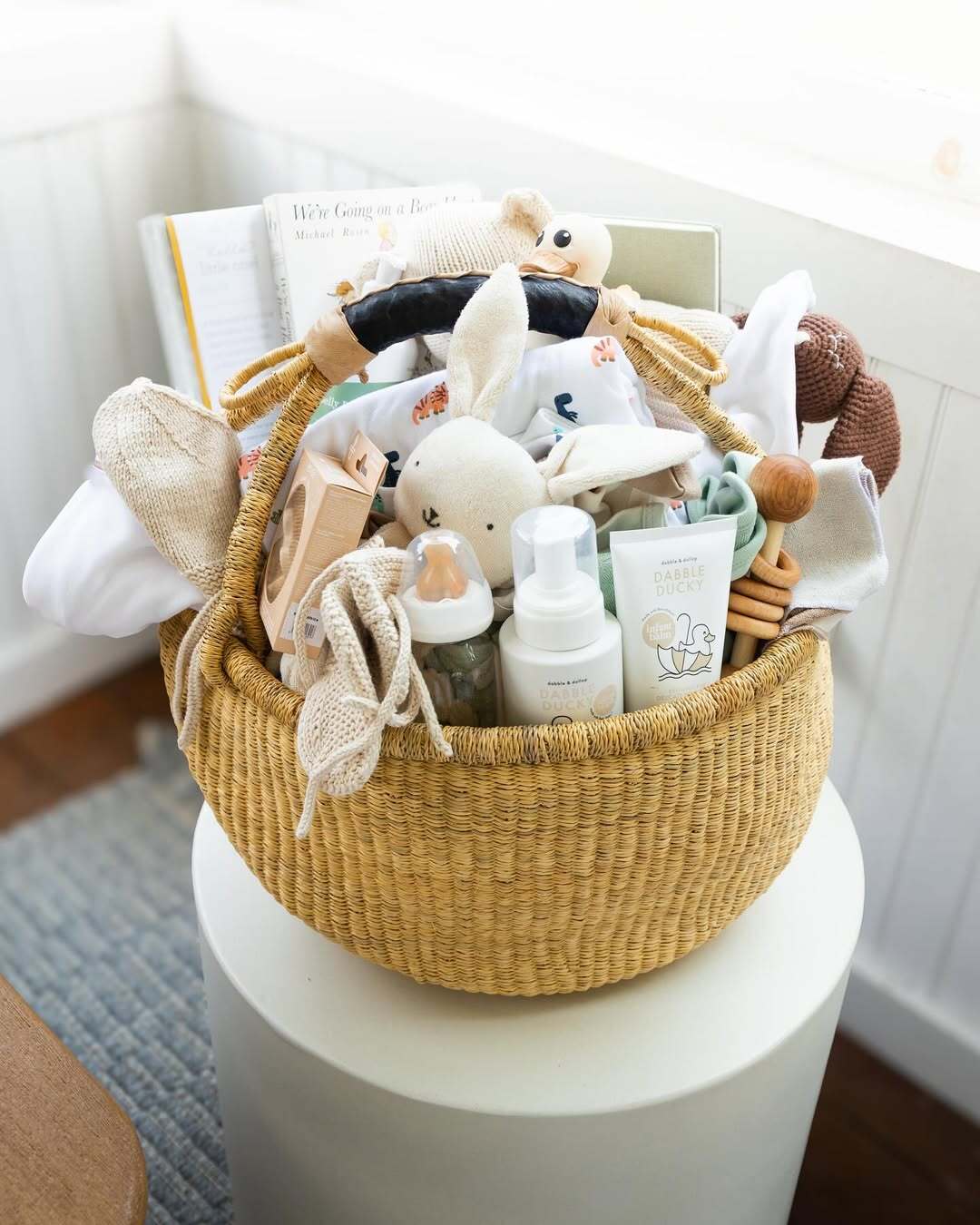 A curated baby hamper from Our Green House filled with books, toys, and organic essentials.