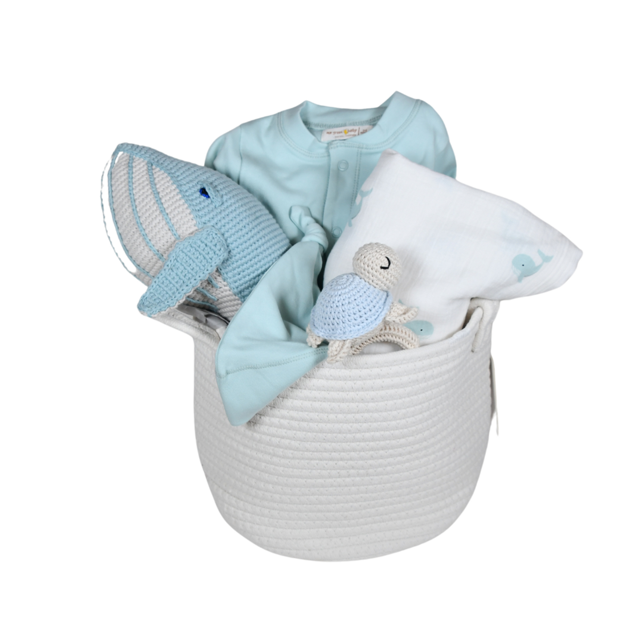 Blue ocean-themed baby gift basket with knit whale, turtle toys, outfit, and blanket in a white rope basket.