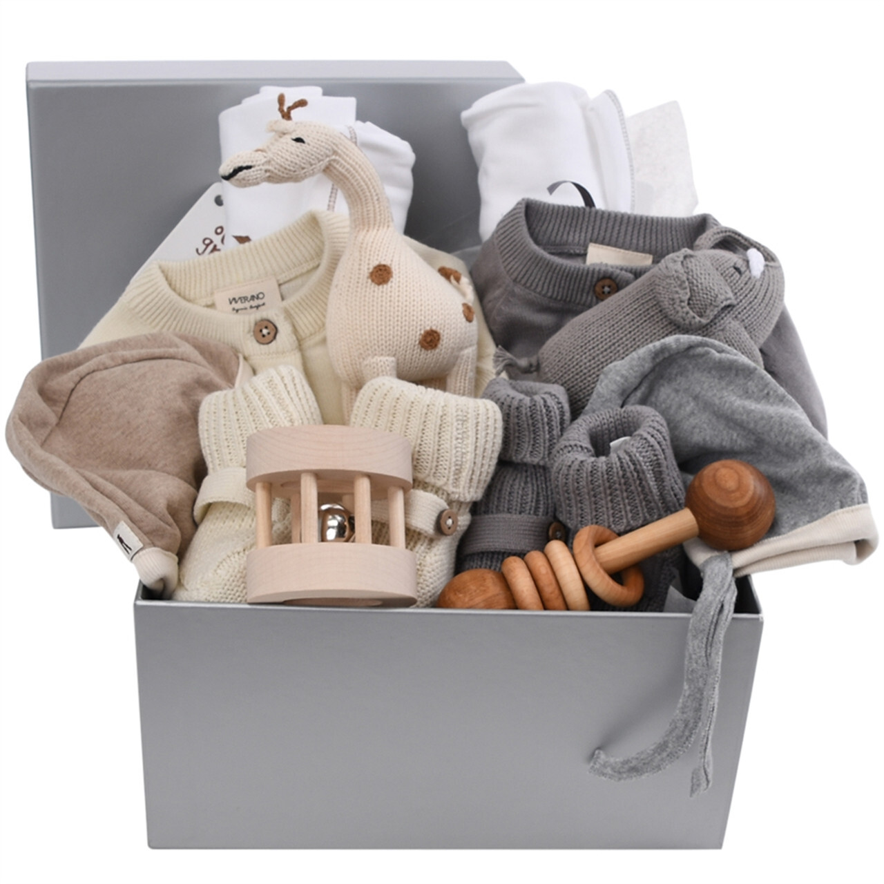Gray gift box with neutral-colored baby clothes, a giraffe toy, and wooden rattles, all from Our Green House.