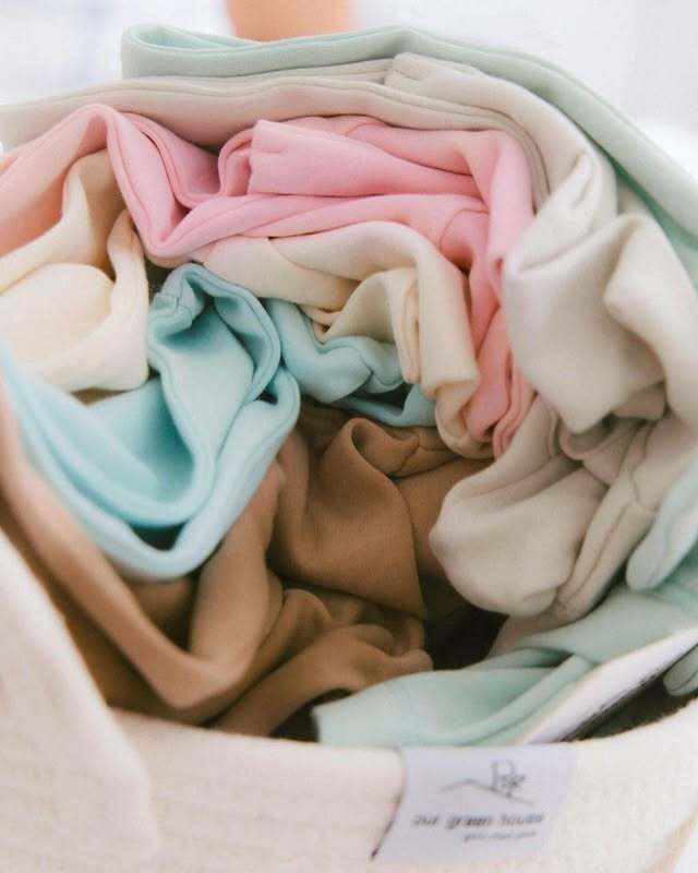 Soft pastel-colored organic cotton onesies for babies from Our Green House.