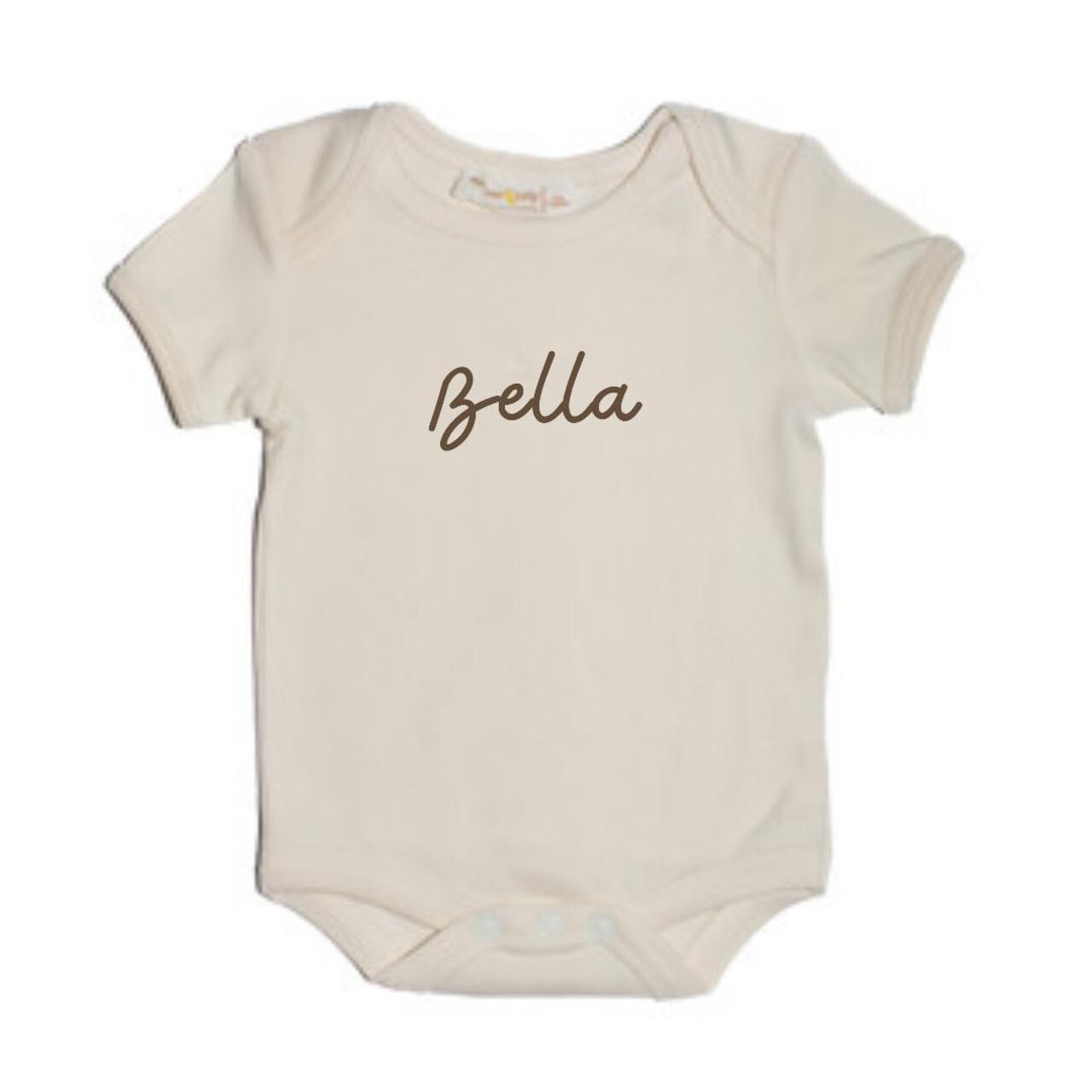 A cream-colored baby onesie from Our Green House, with the personalized name ‘Bella’ printed.