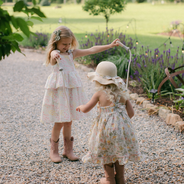 Two girls playing with a rope outdoors.