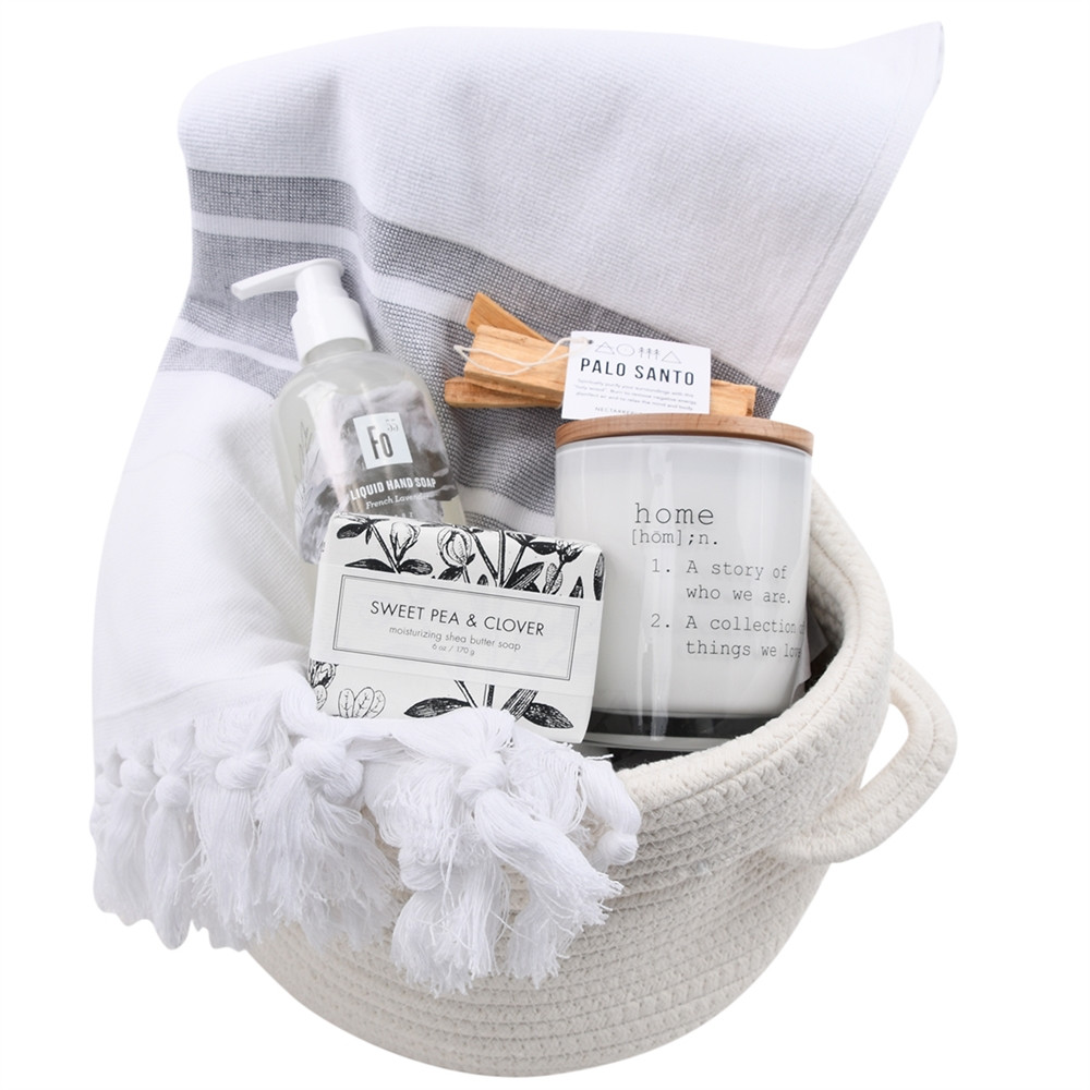 Large housewarming gift basket filled with cozy and practical home essentials arranged in a reusable container.