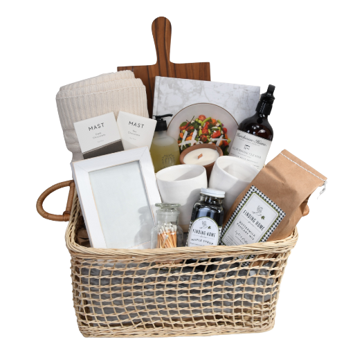 Large housewarming gift basket filled with cozy home essentials, organic items, and eco-friendly products arranged beautifully