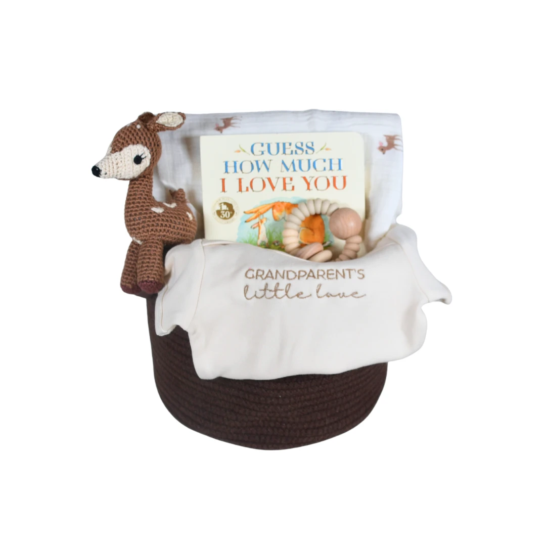 Our Green House baby gift basket with plush toys, wooden teethers, swaddle, and baby care essentials.