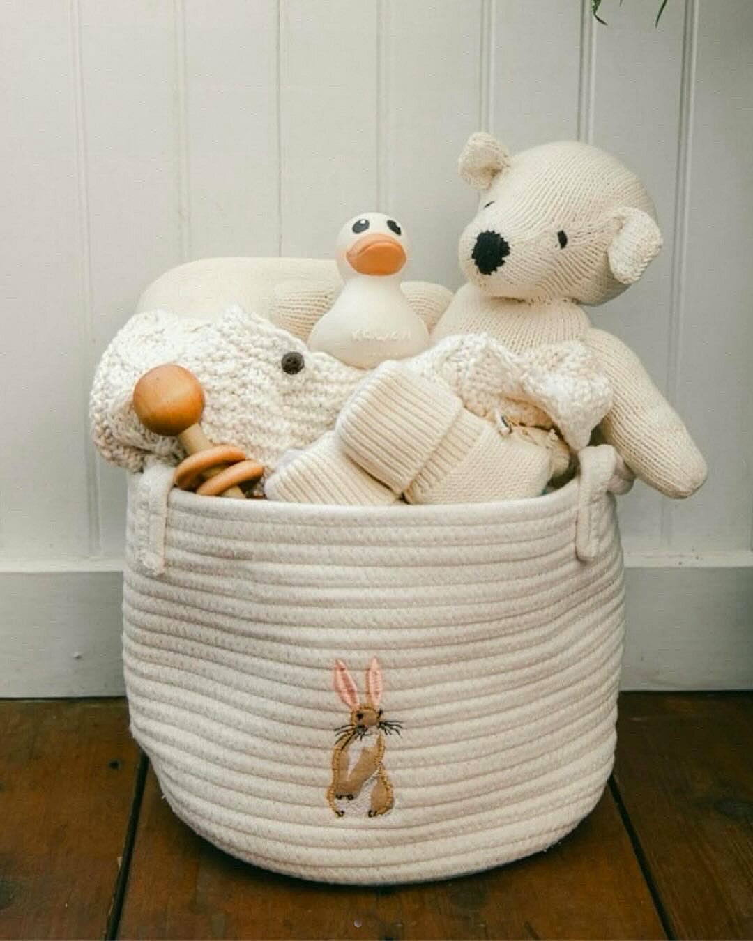 Neutral baby gift basket with knit toys, rubber duck, and embroidered bunny by Our Green House.