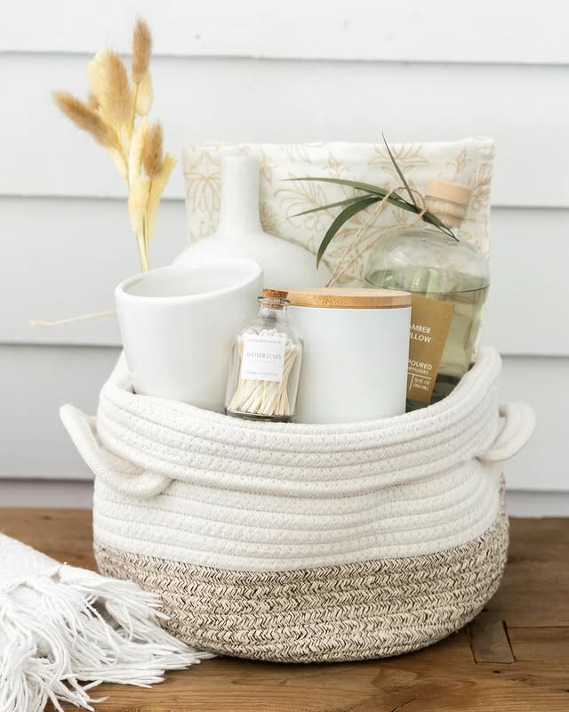 Gift basket wrapped in clear plastic with a ribbon.