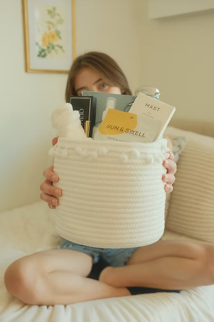 Woman presenting a gift basket