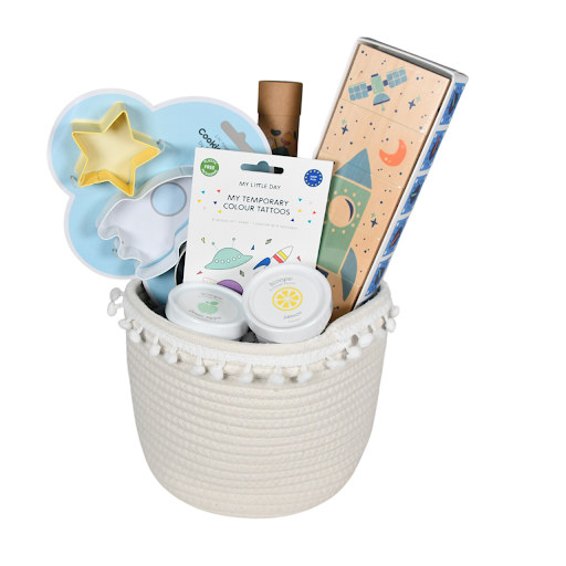 A white woven gift basket with space-themed gifts for kids from Our Green House.