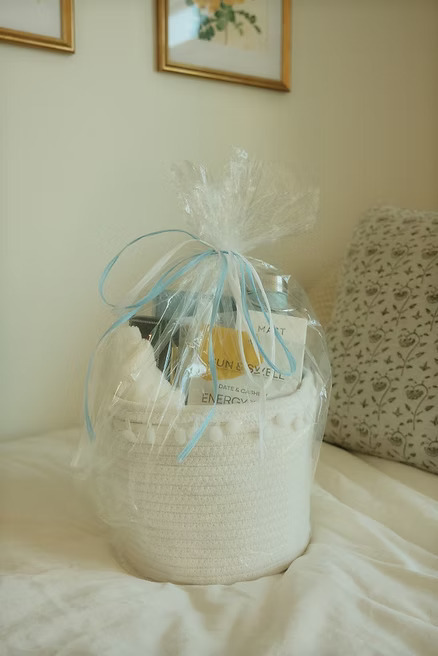 Wrapped gift basket on bed