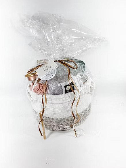  Self-care gift basket with skincare, candles, and accessories.